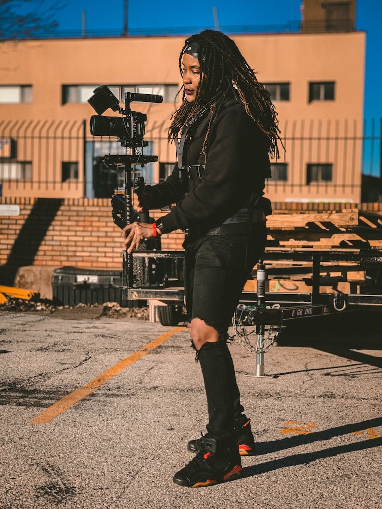 Woman standing with a film camera in an outdoor shoot